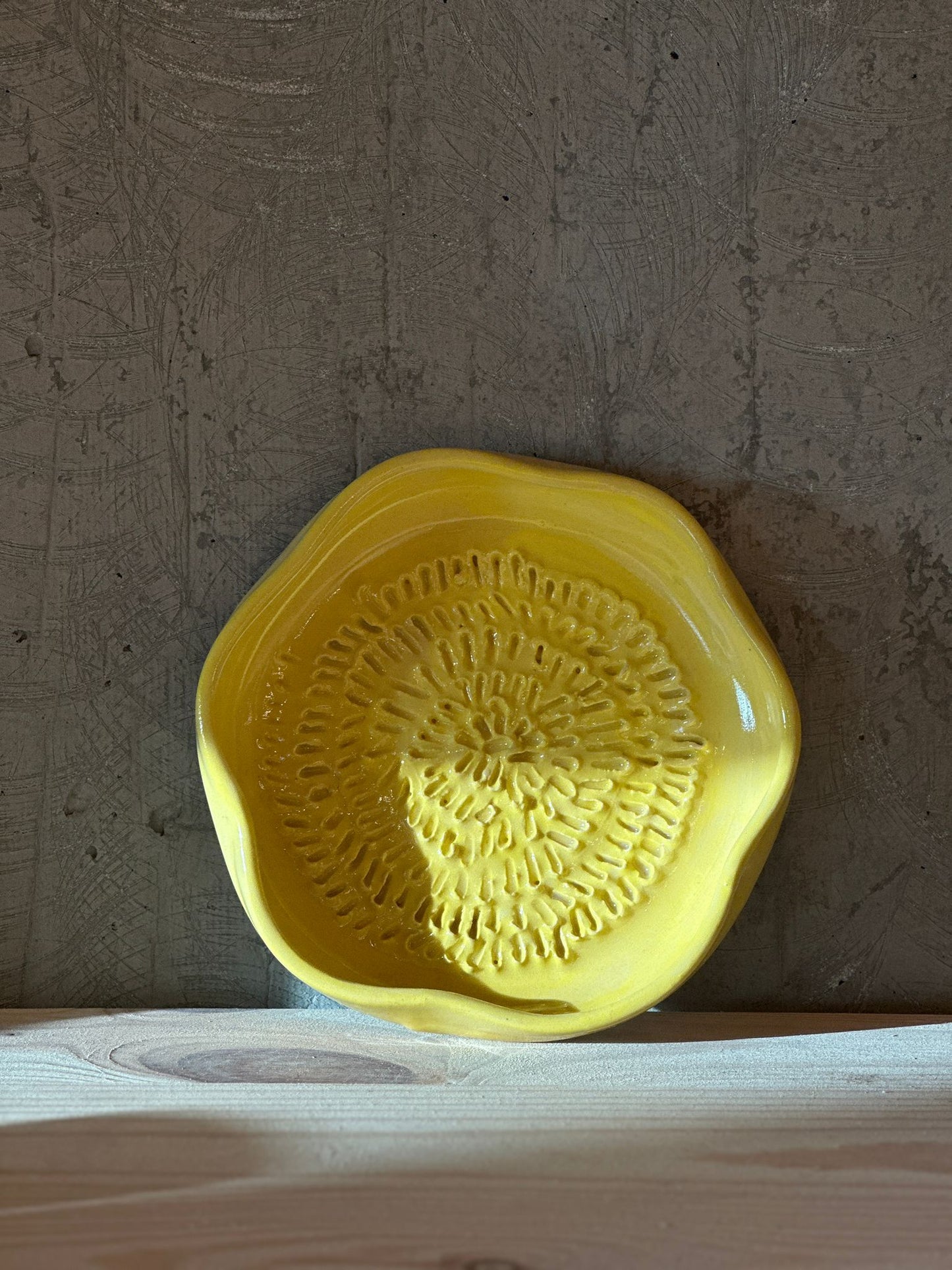 Handmade yellow ceramic garlic grater
